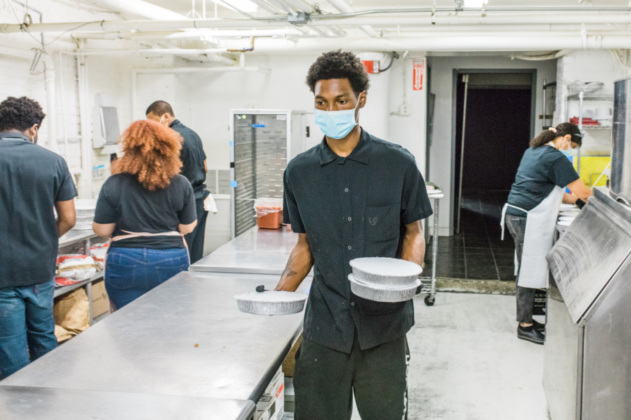 One of Rhodes' staff at the kitchen readies meal kits. Credit: Josh Meredith