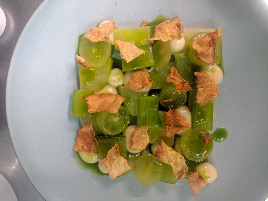 Marinated apples, celery, and grapes with celeriac crisps and purée, and lovage oil. 