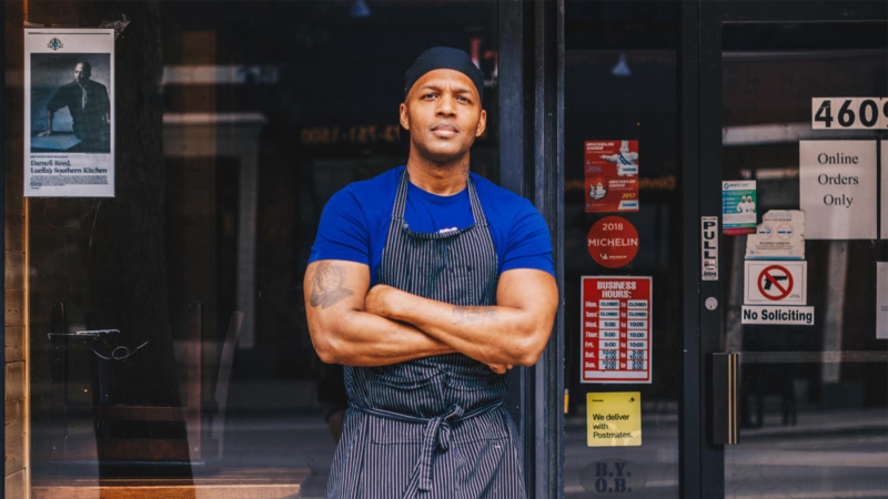 Darnell Reed in front of his restaurant, Luella's Southern Kitchen.