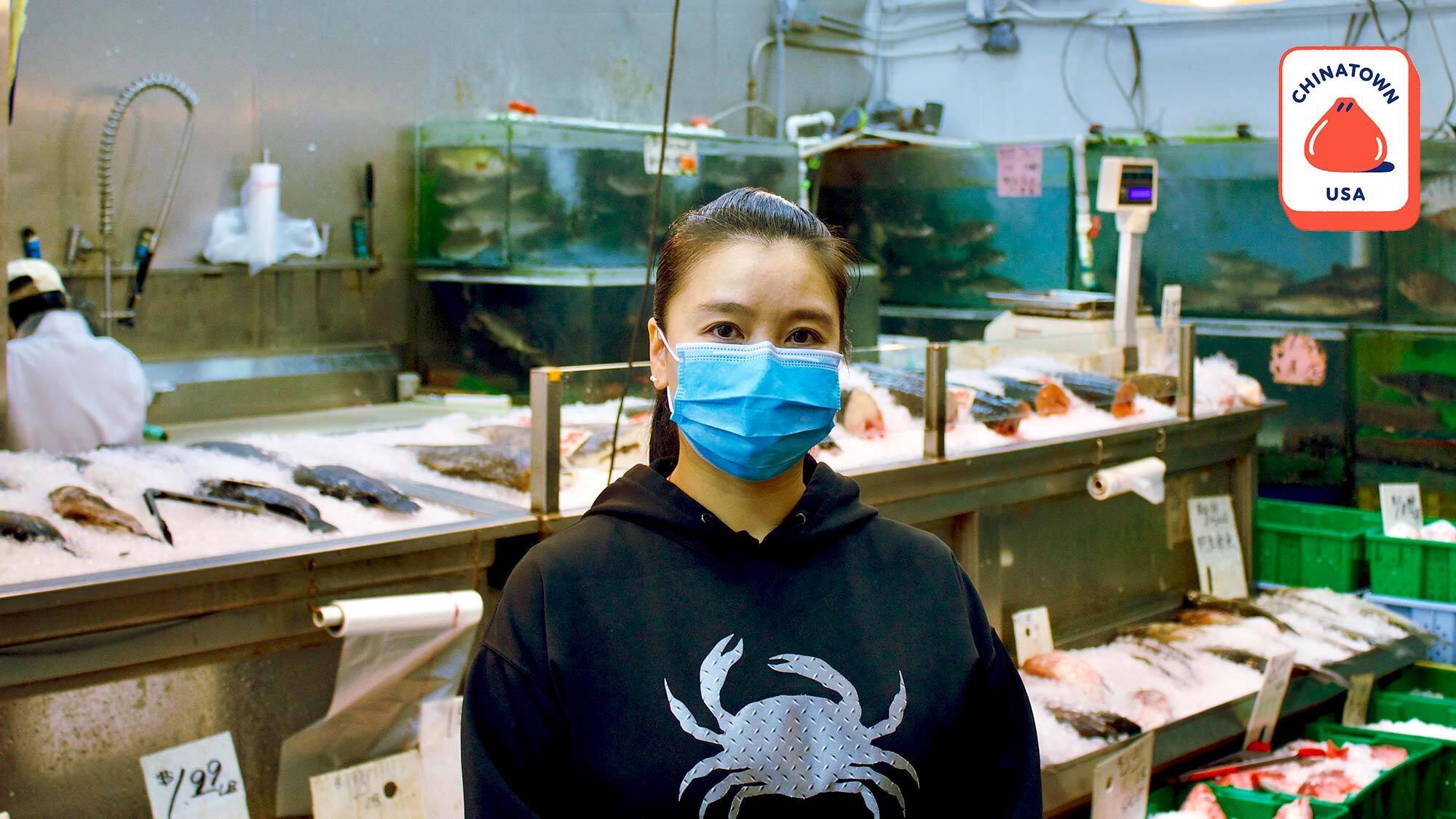 Finnie Phung in front of the seafood counter at her family's business, Green Fish Market. // Photo by Momo Chang for Resy