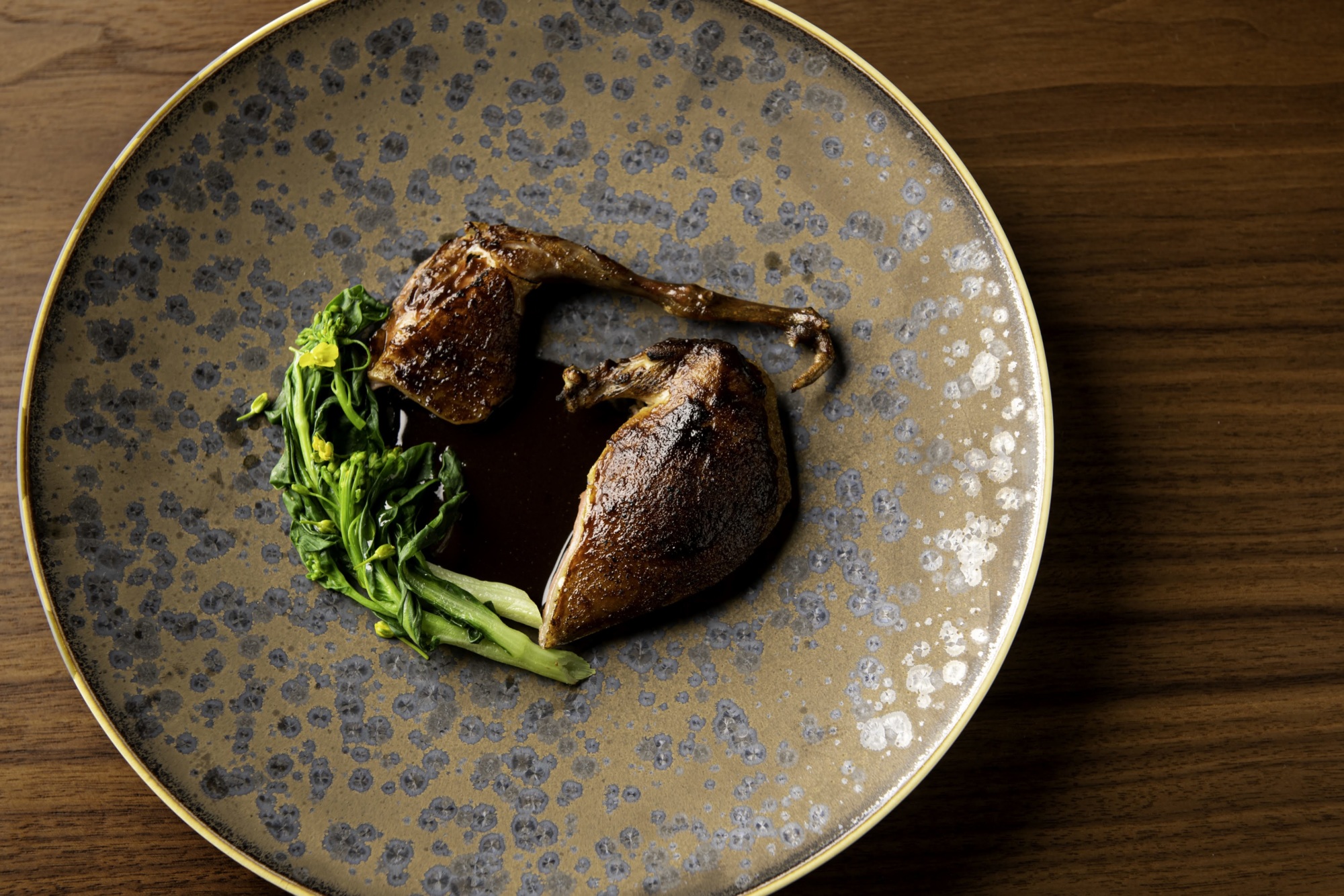 The roasted squab dish features a red miso glaze and a sauce inspired by Mexican mole.