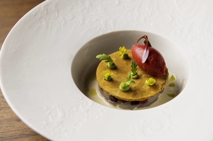 The scallop tartare features a delicate pastry topping and a savory sorbet made with beets and gazpacho.