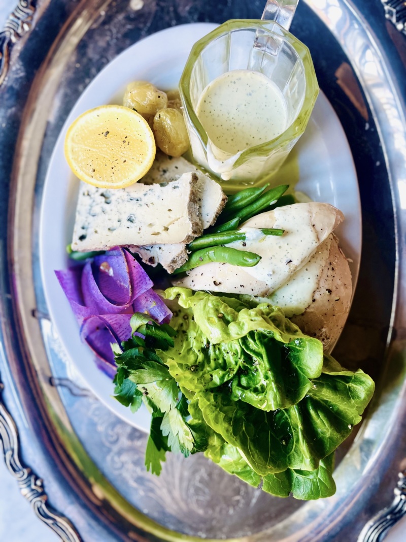 The Ritzy-Titzy Plate, served at lunch, has poached chicken, buttermilk dressing, Dansk blue cheese, pickled grape, green beans, and gem lettuce.