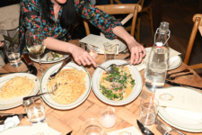 A diner helps herself to pasta during Rosemary's 10th anniversary party.