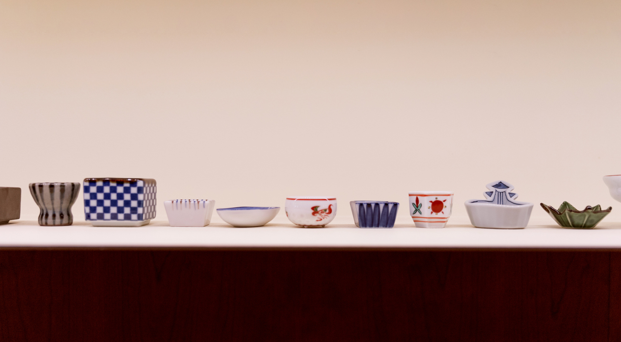 A row of sake cups at Towa