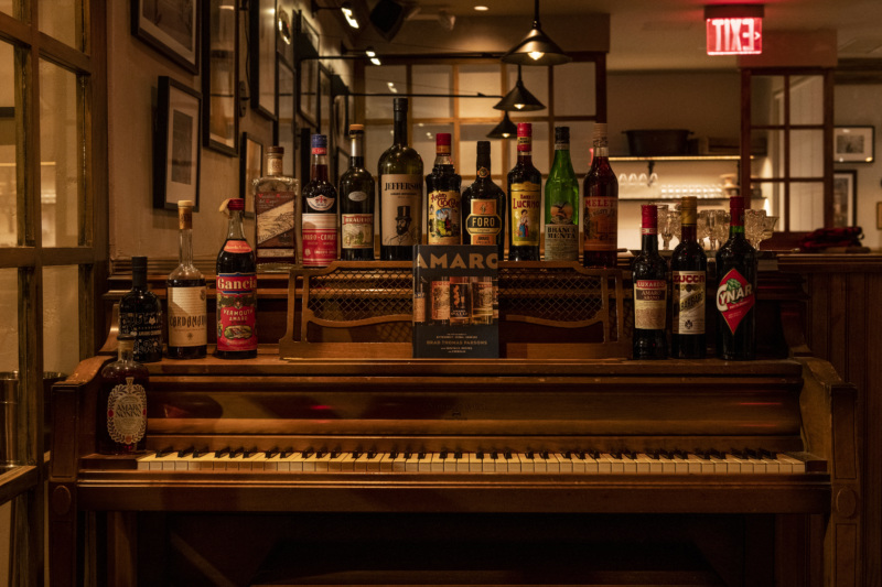 A display of different amari from all over Italy, atop the vintage piano that sits in the restaurant.