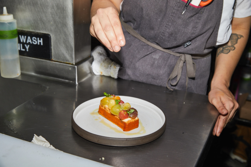 A chef puts the finishing touches on a dish from Dirt Candy's summer tasting menu.