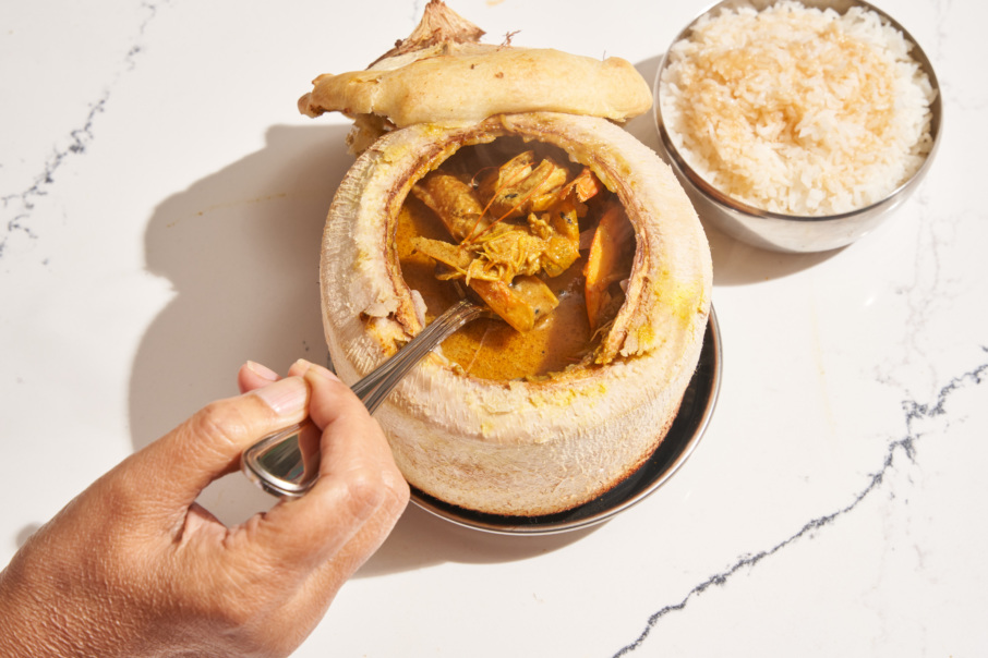 Daab chingri features prawns cooked inside of a young coconut.