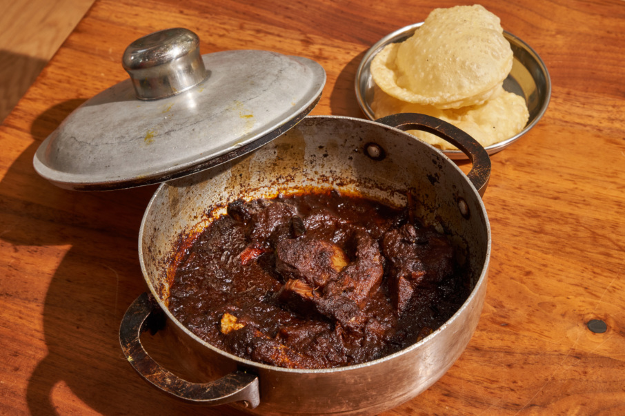 Kosha Mangsho, a braised lamb dish, comes with fried bread (luchi).