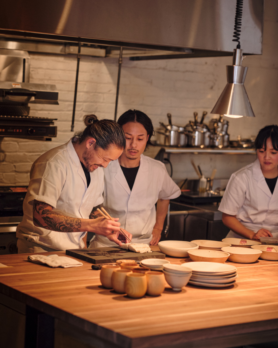 Inside the open kitchen at House Brooklyn, Tani takes care to show his chefs how to prepare each course.