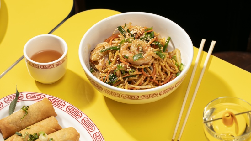 Egg rolls are pictured alongside some shrimp lo mein.