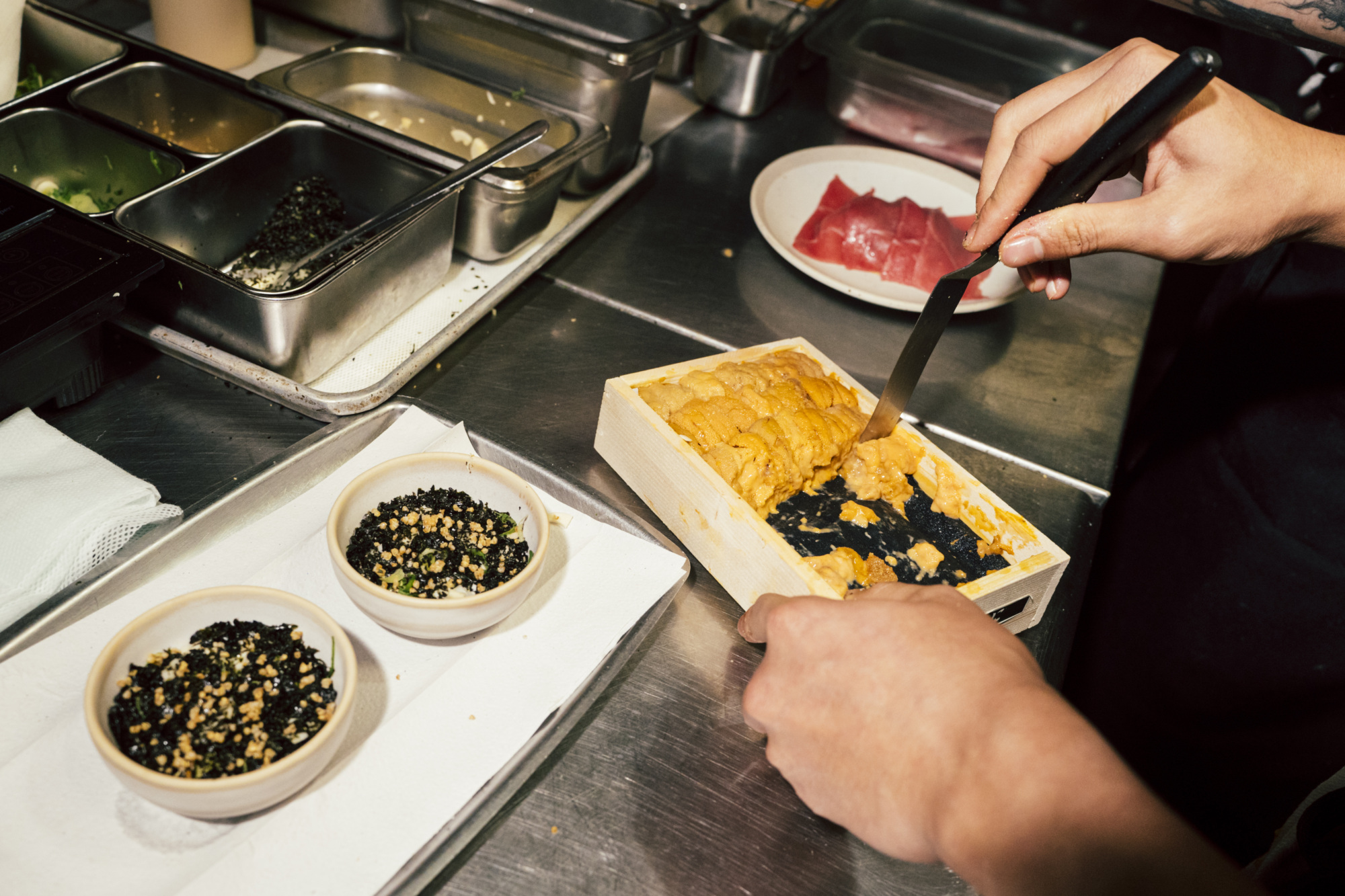 Adding uni to a dish at Atoboy