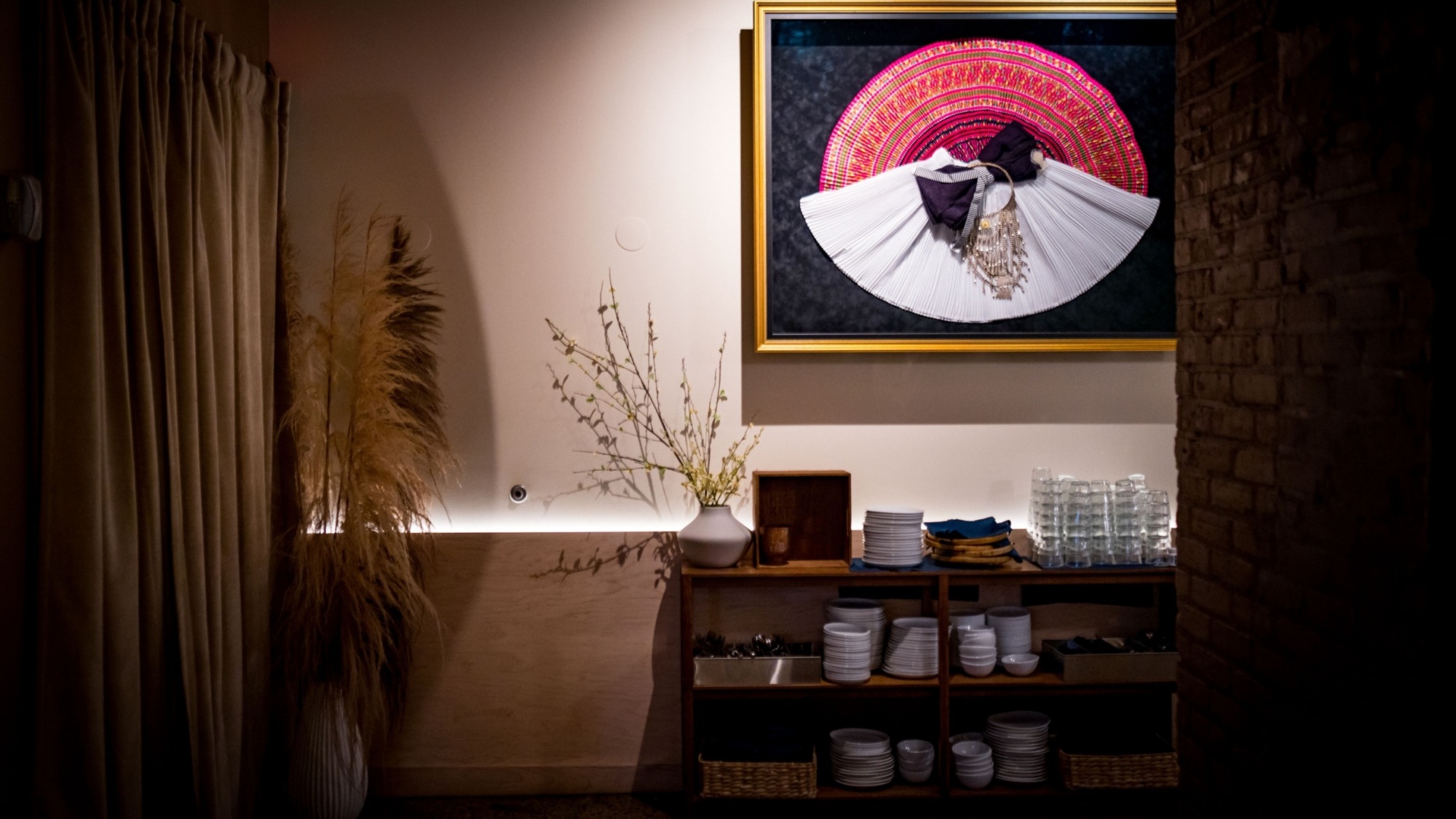 Chef-owner Diane Moua's traditional Hmong wedding garments hang on the wall at Diane's Plac