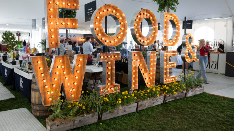 An illuminated sign made of lightbulbs spells out Food and Wine