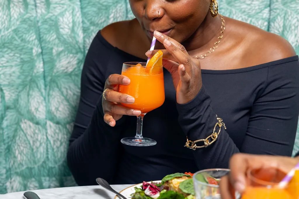 woman sipping cocktail