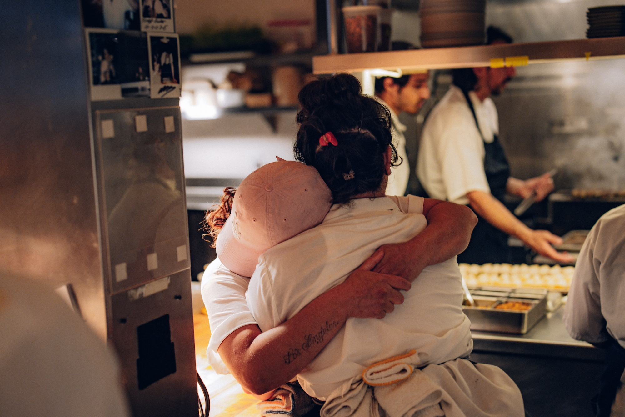 Cooks hugging at Mister Jiu's