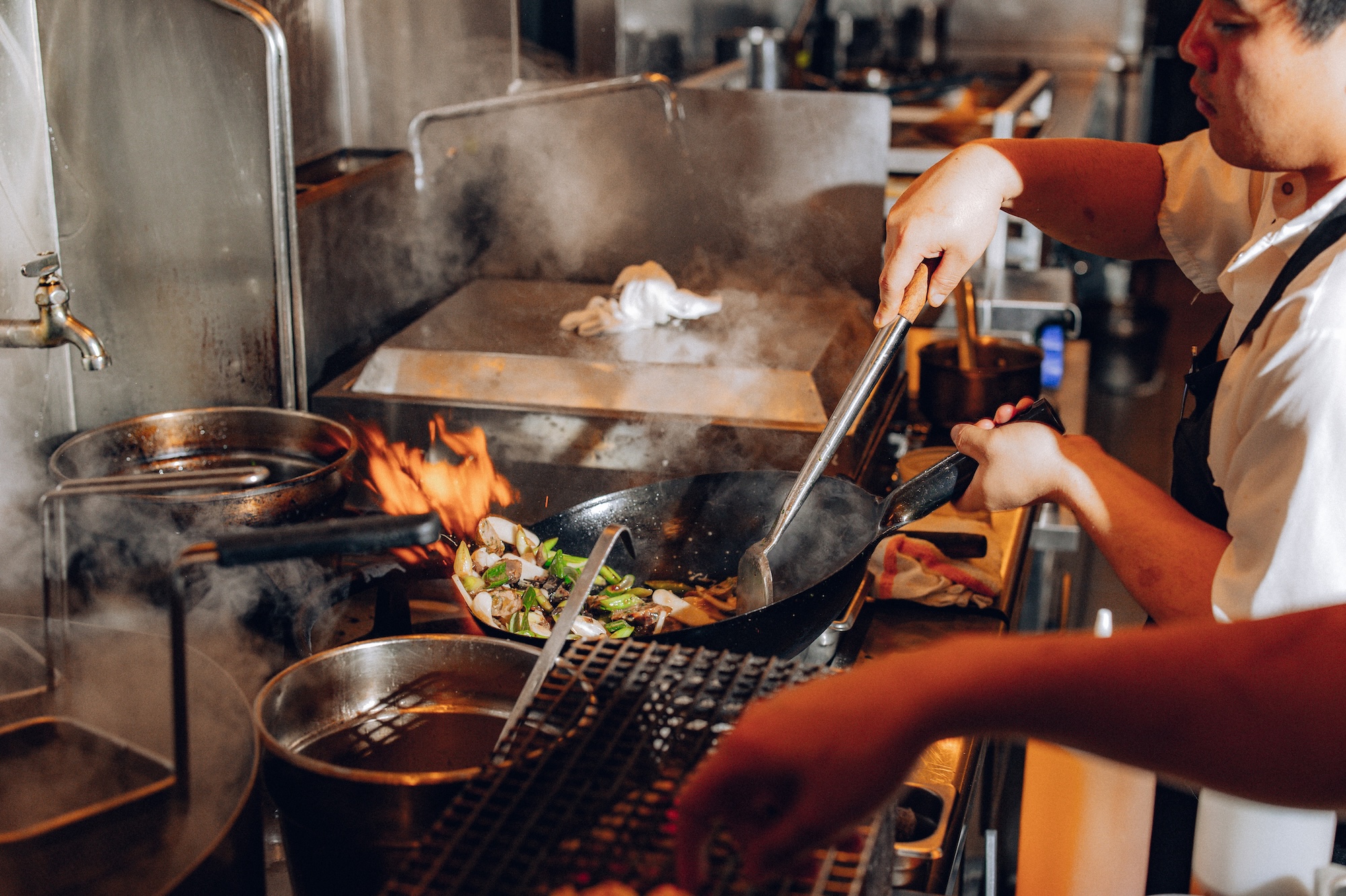 The wok station at Mister Jiu's