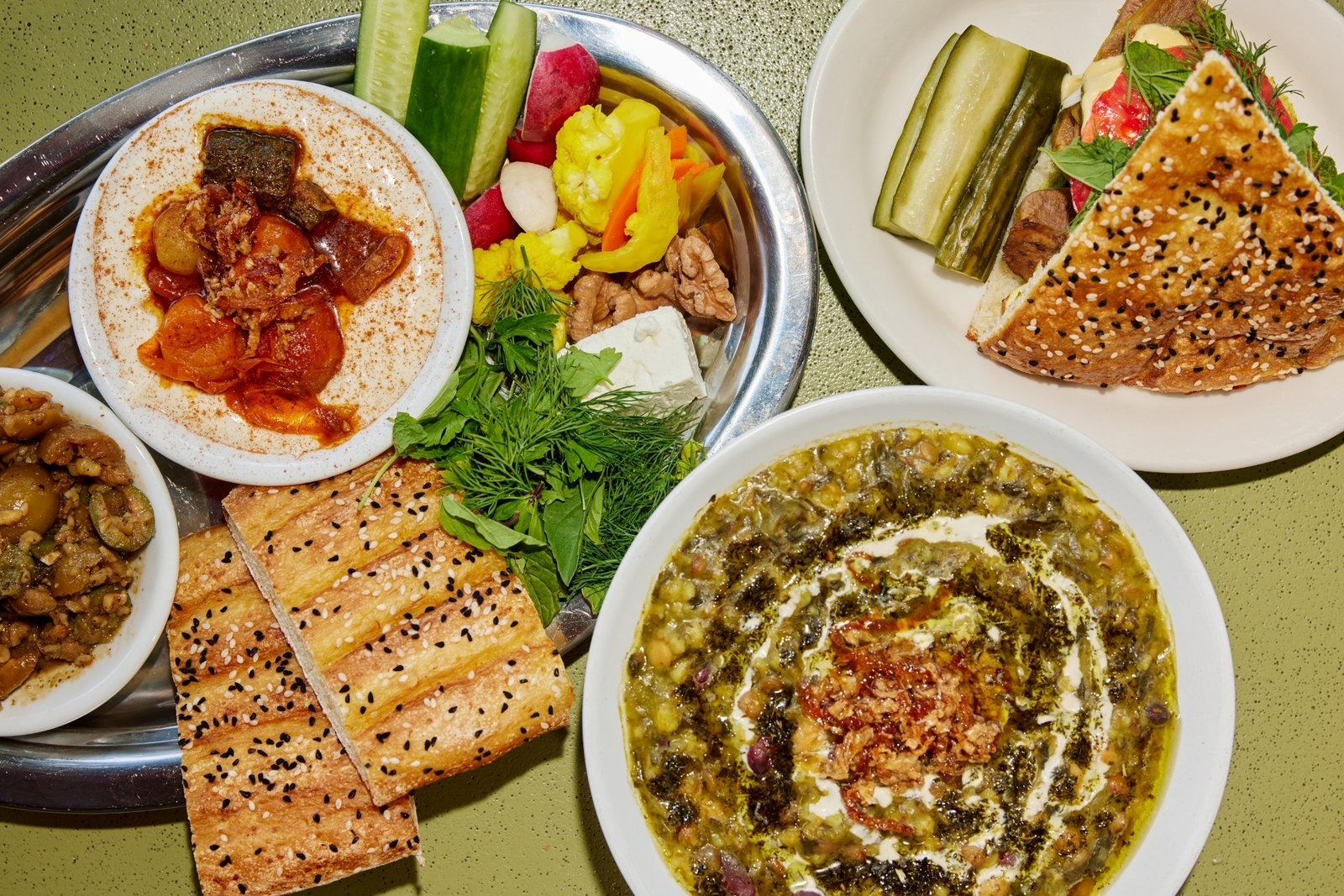 Plated dishes with colorful breads and spreads