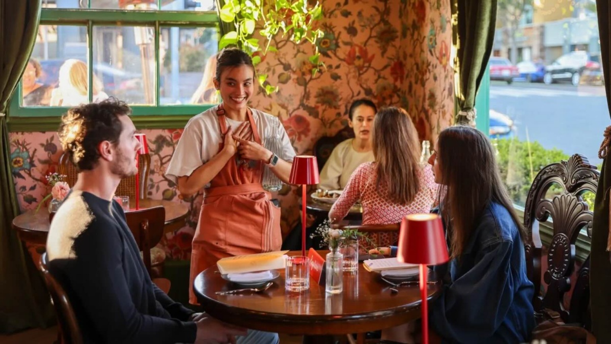 restaurant with waitress in red apron