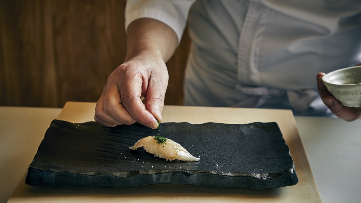 sushi on a black rectangular plate
