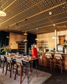 A person walks through the dining room of Troubadour Bread and Bistro