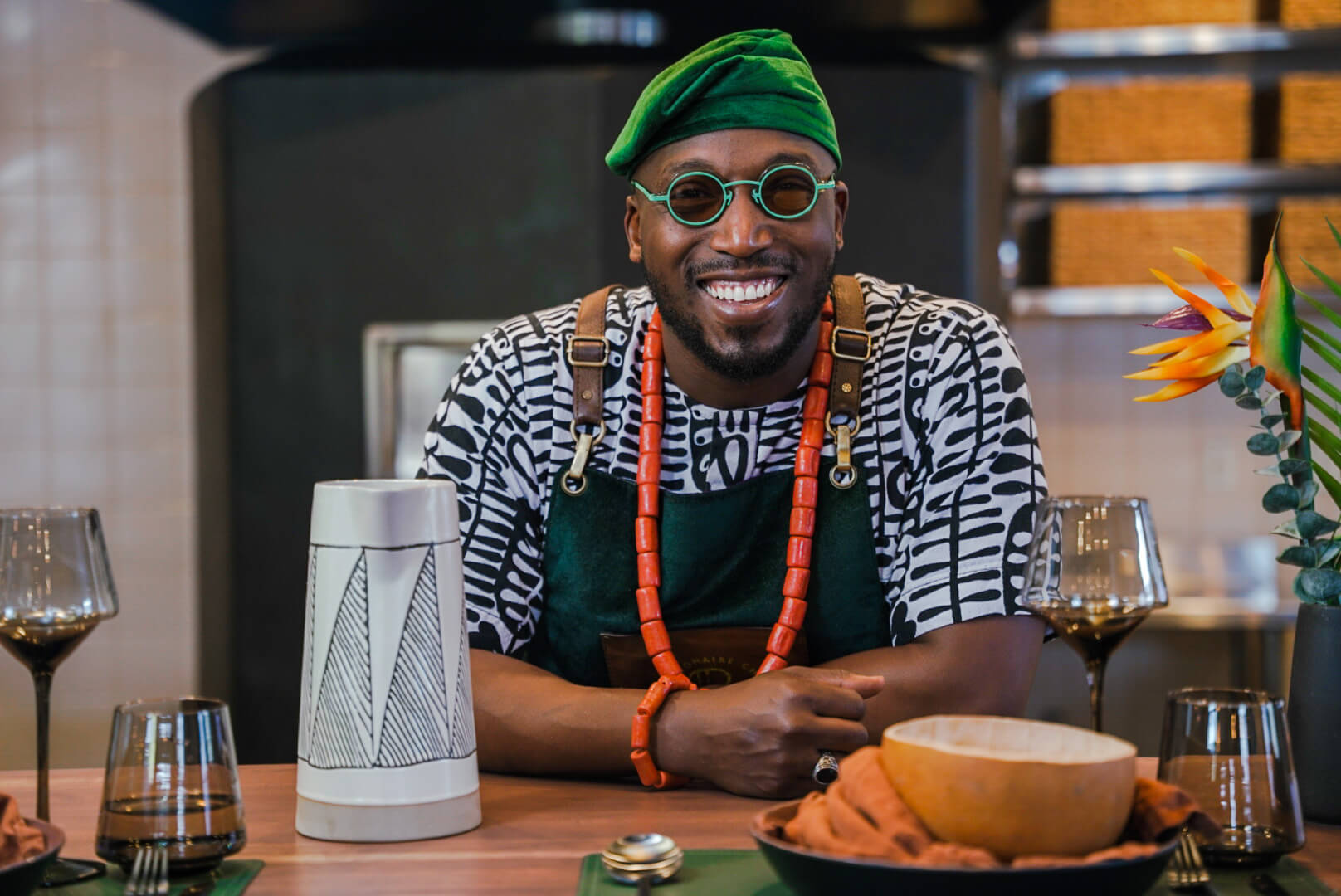 Chef Tolu Eros smiles while seated at a table
